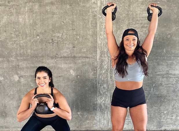 Picture of trainers, Arianna Brusa and Becca Jorge doing weighted squats